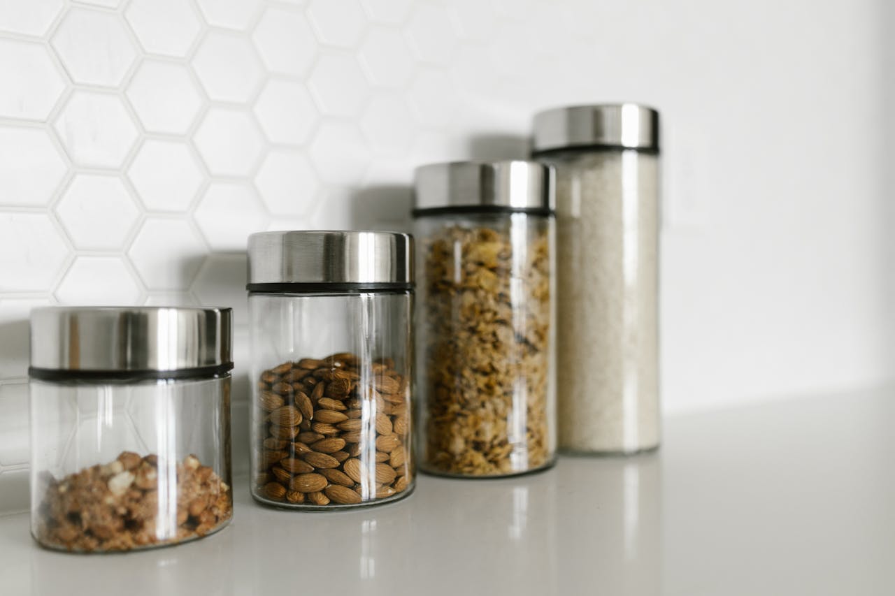 Stylish glass jars filled with food for a modern kitchen organization.